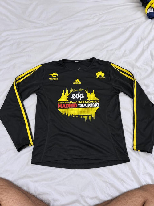 Black and yellow long sleeve football training top shown from the front