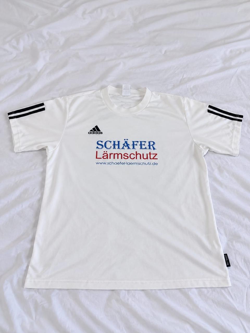 White, black, blue, and red short sleeve sports jersey shown from the front