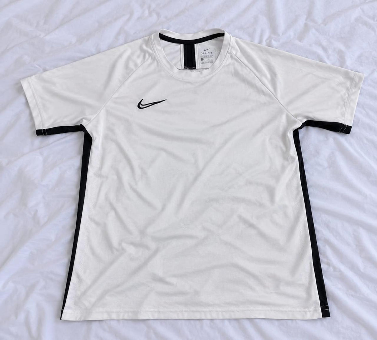 White and black short sleeve sports jersey shown from the front