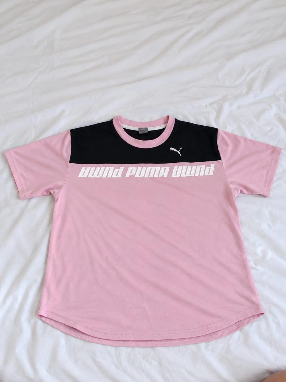 Pink, black, and white short sleeve sports shirt shown from the front